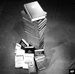 Undated photo of the Warren Commission Report shown with conspiracy books on the John F. Kennedy assassination.