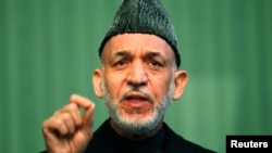 FILE - Afghan President Hamid Karzai speaks during a news conference in Kabul, Jan. 25, 2014. 