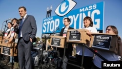 U.S. Representative Justin Amash (R-MI) smiles as he accepts a petition organizers said represented 575,000 people calling for congressional hearings about U.S. spy programs.