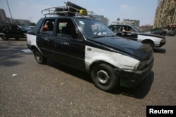 FILE - An old taxi is pictured on a street in Cairo.