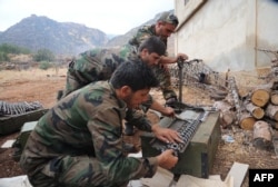A handout picture released by the official Syrian Arab News Agency (SANA) on Oct. 8, 2015, shows pro-government forces preparing ammunition at an undisclosed location in western Syria.