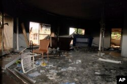 FILE - Glass, debris and overturned furniture are strewn inside a room in the gutted U.S. consulate in Benghazi, Libya, after an attack that killed four Americans, including Ambassador Chris Stevens, Sept. 12, 2012.