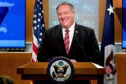 FILE - U.S. Secretary of State Mike Pompeo smiles during a news conference at the State Department, in Washington, April 29, 2020.