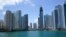 FILE - The skyline of Miami is seen at the entrance to the Miami River from a boat on Biscayne Bay, May 9, 2022.