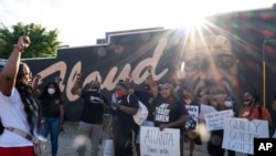 People gather before a march in Atlanta, Tuesday, April 20, 2021, after former Minneapolis police Officer Derek Chauvin was found guilty on all counts in the death of George Floyd. (AP Photo/Ben Gray)