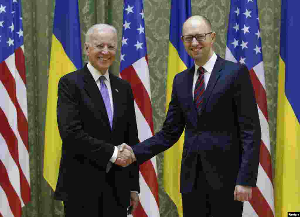 U.S. Vice President Joe Biden shakes hands with Ukrainian Prime Minister Arseniy Yatsenyuk during their meeting in Kyiv, Nov. 21, 2014.