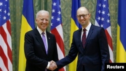 U.S. Vice President Joe Biden shakes hands with Ukrainian Prime Minister Arseniy Yatsenyuk during their meeting in Kyiv, November 21, 2014.