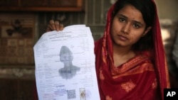 In this April 14, 2019 photo, Mahek Liaqat, who married a Chinese national, shows her marriage certificate in Gujranwala, Pakistan. Poor Pakistani Christian girls are being lured into marriages with Chinese men, whom they are told are Christian and wealth