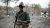 A rebel fighter carries a rocket-propelled grenade (RPG) in a rebel camp in Jonglei state.