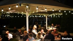 People have drinks before pubs close ahead of a lockdown in Vauxhall, London, Nov. 4, 2020.