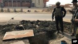 A soldier with Iraq's elite counterterrorism force inspects a tunnel made by Islamic State militants in Bartella, Iraq, Oct. 27, 2016. The town of Bartella in northern Iraq is about 20 kilometers east of Mosul.