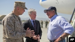 U.S. Secretary of Defense Leon Panetta, right, speaks with U.S. Ambassador Ryan Crocker, center, and General John Allen upon his arrival in Kabul, Afghanistan, June 7, 2012.