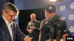Retired Lt. Gen. Michael Flynn signs autographs at the wing of the stage. (Carolyn Presutti/VOA)