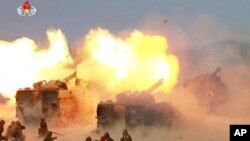 FILE - This image broadcast by North Korea's KRT on April 26, 2017, shows a "combined fire demonstration" in Wonsan, North Korea. The U.S. has accused North Korea on Nov. 2, 2022, of covertly shipping artillery shells to Russia for use in Ukraine.