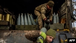 Ukrainian artillerymen unload shells from a military truck at a position on the front line near the town of Bakhmut, in eastern Ukraine's Donetsk region, on October 31, 2022, amid the Russian invasion of Ukraine.