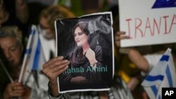 FILE - Women attend a protest against the death of Mahsa Amini, a woman who died while in police custody in Iran, during a rally in Tel Aviv, Oct. 29, 2022.