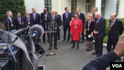 Seventeen recipients of National Medals of Science & National Medals of Technology & Innovation speak to reporters at White House. (A. Pande/VOA)