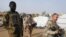 FILE - Soldiers of the Barkhane Force and the Malian army patrol in a market of Menaka, in the region of Liptako, Mali, March 21, 2019