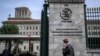 A man phones with his mobile while entering the World Trade Organization (WTO) headquarters in Geneva, Apr. 12, 2022. 