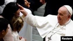 Pope Francis is greeted by people during the weekly general audience at the Vatican, Jan. 25, 2023. 