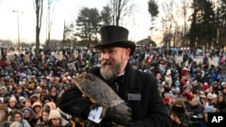 Groundhog Club handler A.J. Dereume holds Punxsutawney Phil, the weather prognosticating groundhog, during the 137th celebration of Groundhog Day on Gobbler's Knob in Punxsutawney, Pa., Feb. 2, 2023.