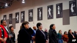 Residents of Gila River Indian Community listen during a 'Road to Healing' event, Jan. 20, 2023, at the Gila Crossing Community School in Laveen, Ariz.