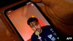 Video dalam layar telepon genggam yang menunjukkan penyanyi asal Iran Shervin Hajipour dalam foto yang diambil pada 4 Oktober 2022. (Foto: AFP/Khaled Desouki)
