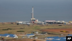 The drilling rig of the Kingfisher oil field, operated by China National Offshore Oil Corporation (CNOOC), is seen on the shores of Lake Albert in the Kikuube district of western Uganda, Jan. 24, 2023. 