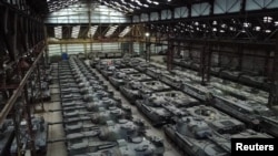 Dozens of German-made Leopard 1 tanks and other armored vehicles are seen in a hangar in Tournais, Belgium, Jan. 31, 2023.