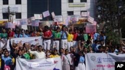 School students participate in an awareness walk to mark World Cancer Day in Hyderabad, India, Saturday, Feb. 4, 2023.