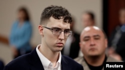 FILE - El Paso Walmart accused mass shooter Patrick Crusius, a 21-year-old male from Allen, Texas, accused of killing 22 and injuring 25, is arraigned, in El Paso, Texas, Oct. 10, 2019.