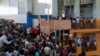 Haitians Seen Crowding Into Migration Centers Seeking Passports To US 