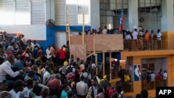 FILE - Haitians wait to apply for passports at the Vincent gymnasium in Port-au-Prince on Jan. 23, 2023.