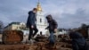 Children stand atop of a destroyed Russian vehicle in the city center of Kyiv, Ukraine, Feb. 2, 2023. 