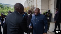 President of Kenya William Ruto, left, is greeted by Burundian President Evariste Ndayishimiye at the Summit of East African Community Heads of State in Bujumbura, Burundi, Feb. 4, 2023. East African leaders were to discuss ways of calming the conflict in eastern DRC.