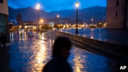 A person walks in a semi-deserted Plaza de Armas in the historic center of Cusco, Peru, Feb. 1, 2023.