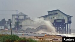 Waves crash on stilt houses along the shore as Hurricane Michael's power is unleashed in Alligator Point, Franklin County, Fla., Oct. 10, 2018.