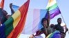FILE - Dozens of people cheer and dance as they take part in the Namibian Lesbians, Gay, Bisexual and Transexual (LGBT) community pride Parade in the streets of the Namibian capital on July 29, 2017 in Windhoek. 