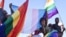 FILE - Dozens of people cheer and dance as they take part in the Namibian Lesbians, Gay, Bisexual and Transexual (LGBT) community pride Parade in the streets of the Namibian capital on July 29, 2017 in Windhoek. 