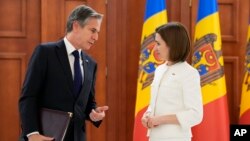U.S. Secretary of State Antony Blinken, left, speaks to Moldova's President Maia Sandu at a joint news conference following their talks in Chisinau, Moldova, March 6, 2022. 
