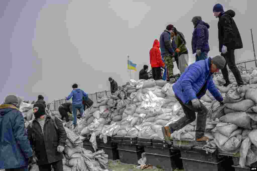 Citizens fill bags with sand for frontlines, along the beach of the Black Sea city of Odessa, in the southern Ukraine, March 7, 2022. Odessa, which Ukraine fears could be the next target of Russia's offensive in the south, is the country's main port and is vital for its economy.&nbsp;