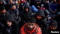 Foreign nationals fleeing Russia's invasion of Ukraine wait at the Shehyni border crossing to enter Poland, near Mostyska, Ukraine, March 1, 2022. 