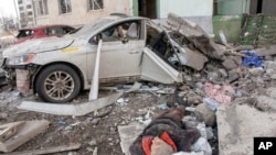 The lifeless body of a man killed in a Russian rocket attack lies amidst the debris, in Kharkiv, Ukraine's second-largest city, March 6, 2022.