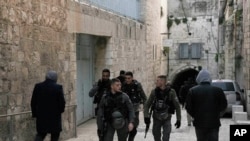 Israeli Border Police patrol in the Old City of Jerusalem as Palestinians walk to the Al Aqsa Mosque compound for prayers, March 6, 2022.