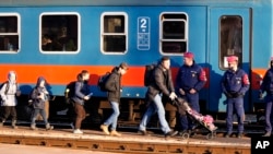 Refugees that fled Ukraine from the war arrive at the train station in Zahony, Hungary, March 6, 2022.