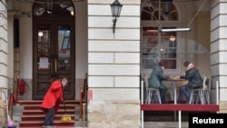 People are seen in a cafe in central Lviv, Ukraine, Feb. 15, 2022.