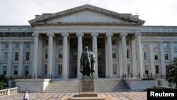 FILE - A man walks away from the U.S Treasury Department in Washington.