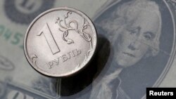 FILE - A view shows a Russian rouble coin and a U.S. dollar banknote in this picture illustration taken October 26, 2018.