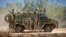 FILE - In this photo provided by the Australian Defense Force, an Australian Army Bushmaster armored vehicle moves off road during a training mission July 7, 2021, in Townsville, Australia. 