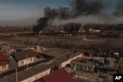 Smoke billows from burning containers after shelling in Vasylkiv, south west of Kyiv, Ukraine, March 12, 2022.